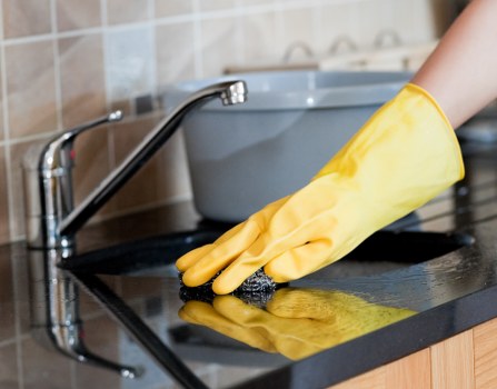Cleaner preparing safety equipment before a deep cleaning task
