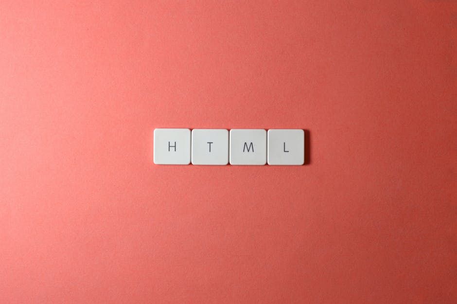 A close-up view of four white square tiles with black letters spelling 'HTML', arranged in a straight line on a smooth, coral-colored background. The tiles are evenly spaced and centered in the image,